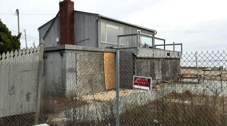 At an auction of storm-damged properties in May,