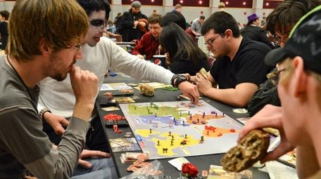 Friends play a board game called Risk Legacy