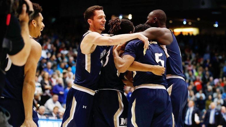 The Mount St. Mary's Mountaineers celebrate defeating the