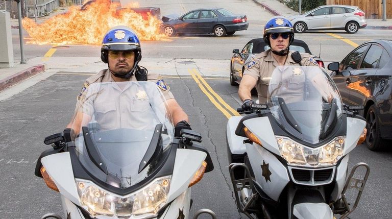 Michael Peña, left, and Dax Shepard ride to