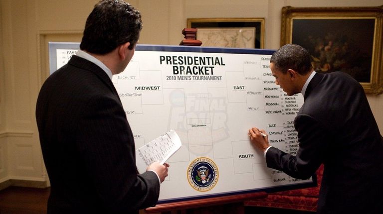 ESPN's Andy Katz watches as President Barack Obama