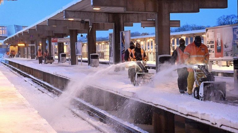 Long Island Rail Road personnel work to clear
