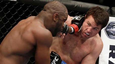 Rashad Evans, left, and Chael Sonnen trade punches