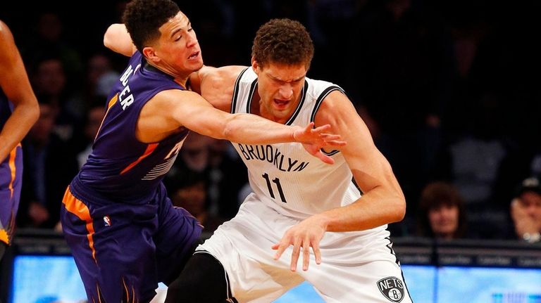 Brook Lopez, #11, of the Brooklyn Nets battles