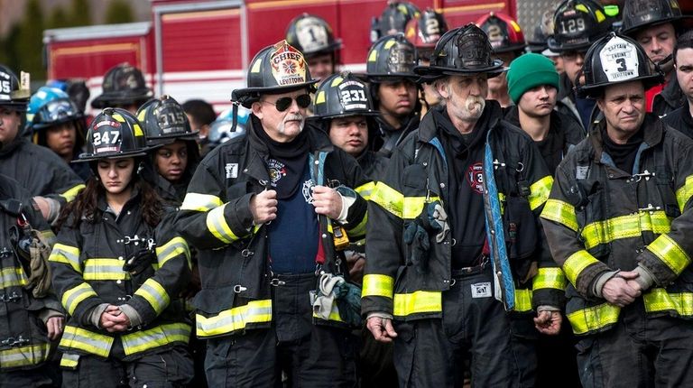 Firefighters from across Nassau County gather during a