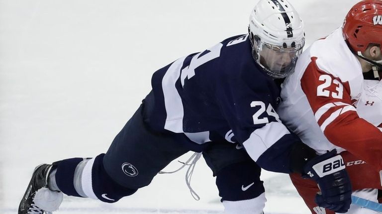 Wisconsin forward Aidan Cavallini (23) passes the puck
