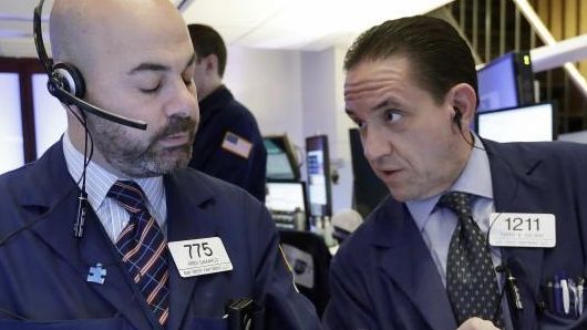 Traders Fred Demarco, left, and Tommy Kalikas work