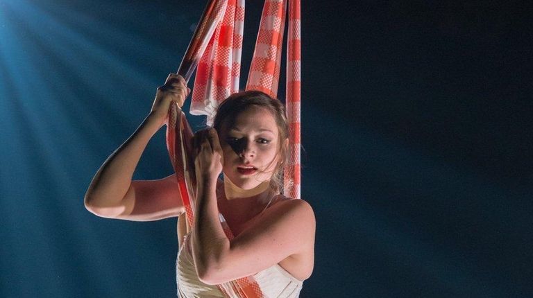 A performer is suspended above the stage in