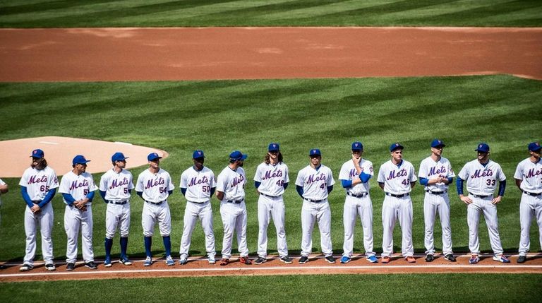 Mets players line up at the start of