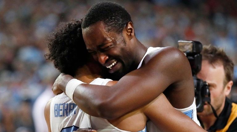 North Carolina forward Theo Pinson, right celebrates with