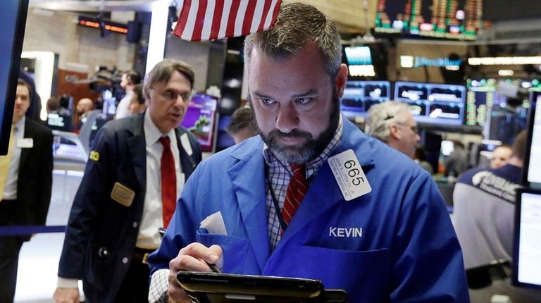 Trader Kevin Lodewick works on the floor of