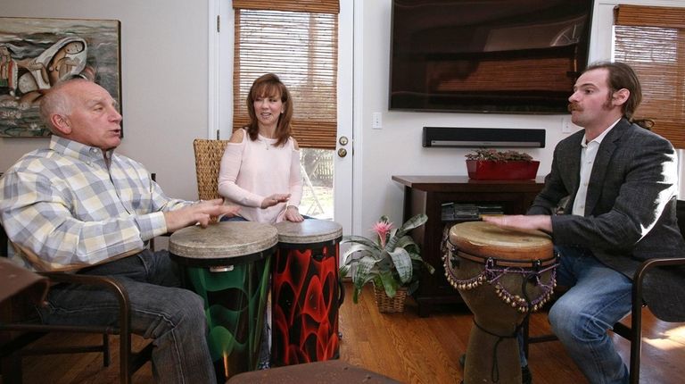 Music therapist Noah Plotkin leads a drumming and