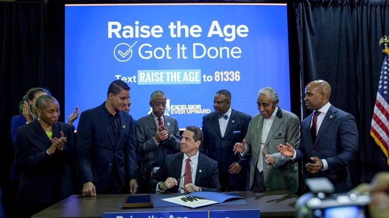 Gov. Andrew M. Cuomo, signing a law on