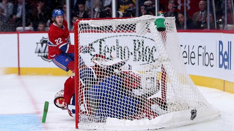 Chris Kreider of the Rangers crashes into Carey