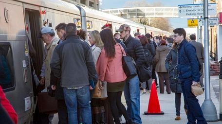 Commuters board the LIRR in Mineola on Friday,