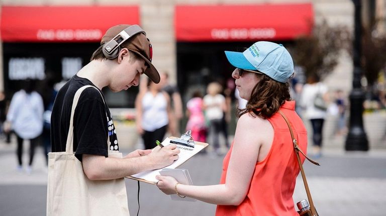 Joanna Levinger, right, signs up Justin Banner for