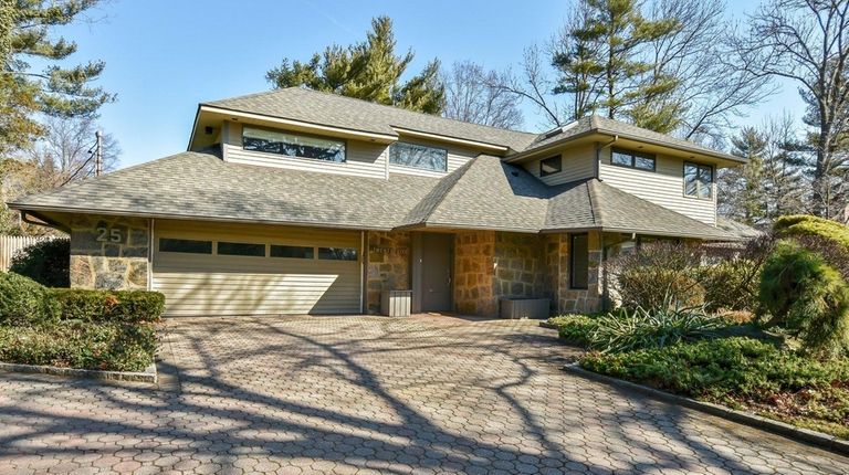 This five-bedroom, four-bath Roslyn Heights home was built
