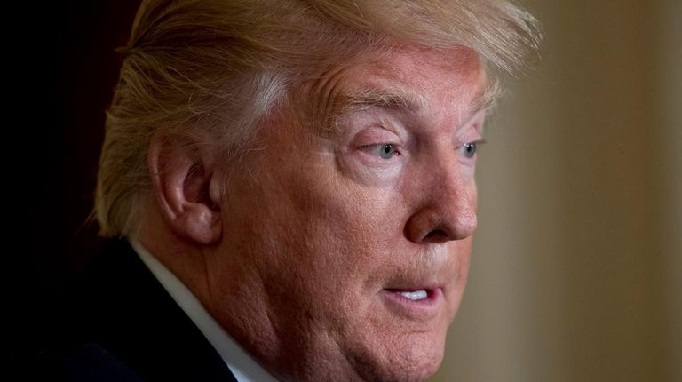 President Donald Trump pauses during a news conference