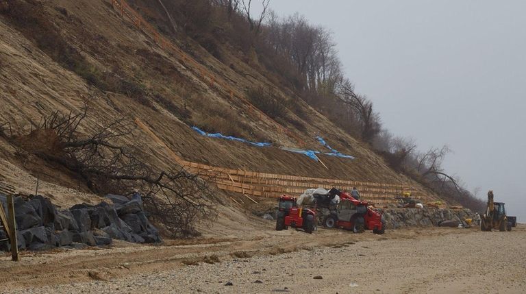 Workers shore up an area near Bluff Road