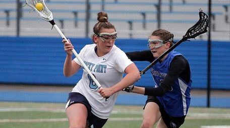 Rocky Point's Madison Sanchez drives against Hauppauge's Katie