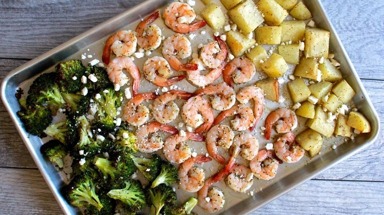 Shrimp, potatoes and broccoli are roasted on a