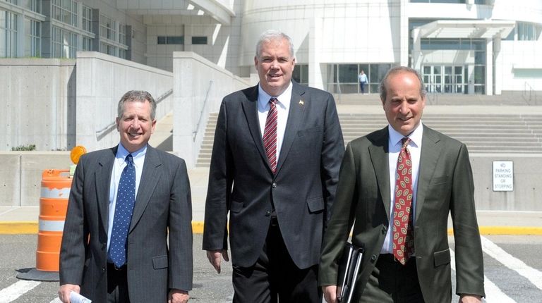 Edward Walsh, center, leaves federal courthouse in Central