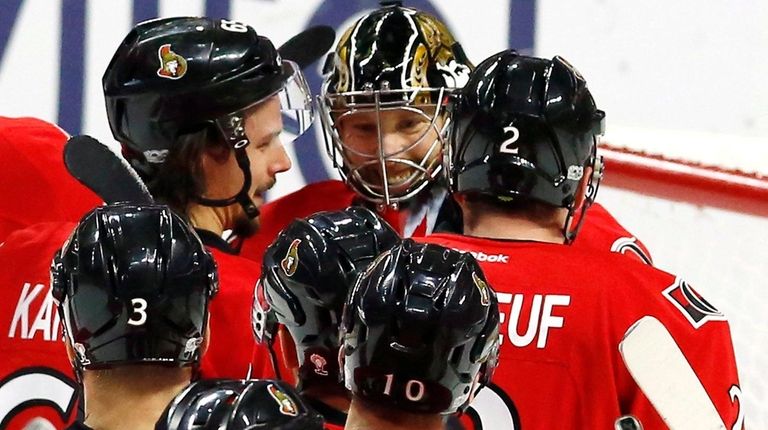 Ottawa Senators goalie Craig Anderson, top center, celebrates