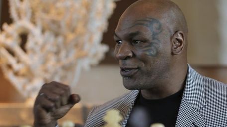 Mike Tyson makes a fist during an interview