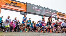 Runners charge through the starting gate of the