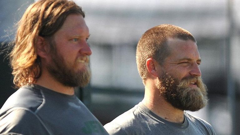 Ryan Fitzpatrick #14, right, stands alongside teammate #74