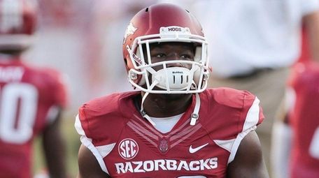 Arkansas running back Rawleigh Williams III stretches before