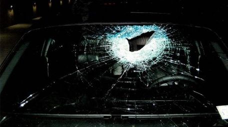 The shattered window of a BMW that was