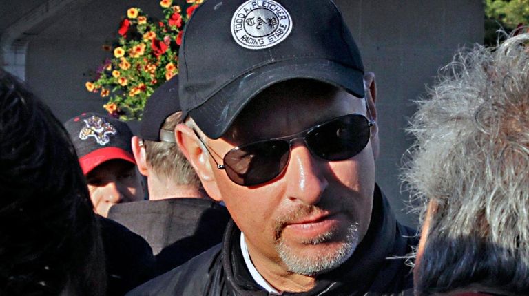 Trainer Todd Pletcher talks to reporters outside Barn