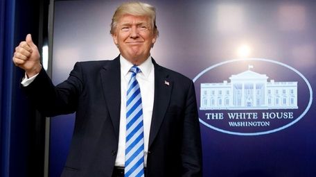 President Donald Trump gives a thumbs-up as he
