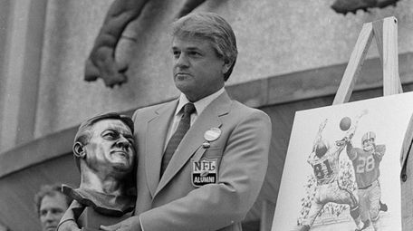 Yale Lary poses with his bust and drawing