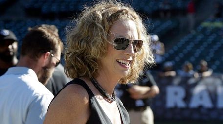 Announcer Beth Mowins walks on the field before