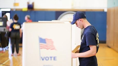 Andrew McShane, 21, of Massapequa, votes in the