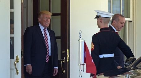 President Donald Trump walks Turkish President Recep Tayyip