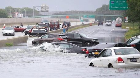 Cars are stuck in floodwaters on Sunrise Highway