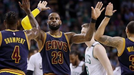 Cleveland Cavaliers forward LeBron James trades high-fives with