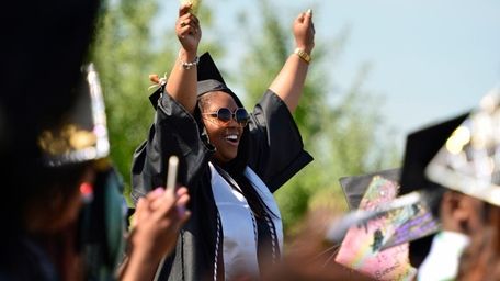 A graduating student wears her customized mortarboard during