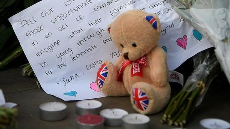 A tribute is laid at a candlelight vigil