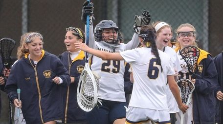 Massapequa celebrates its 12-10 win around goaltender Sophia