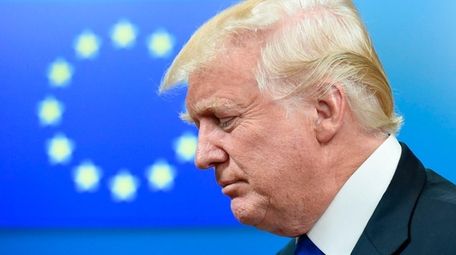 President Donald Trump leaves a meeting with EU
