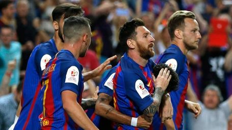 Barcelona's Lionel Messi, second right, celebrates with teammates