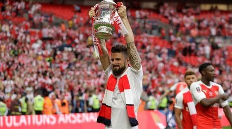 Arsenal's Olivier Giroud celebrates with the trophy after