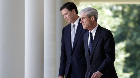 Then-incoming FBI Director James Comey, left, with then-outgoing