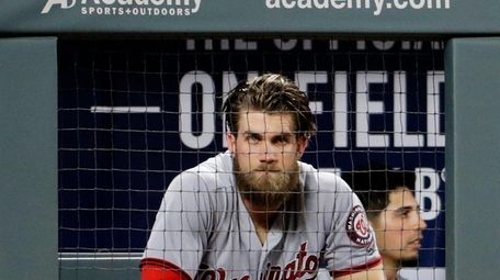 Washington Nationals' Bryce Harper sits in the dugout