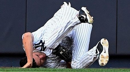 Jacoby Ellsbury rolls to the ground after making