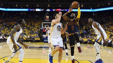 Cleveland Cavaliers guard Kyrie Irving (2-R) goes to